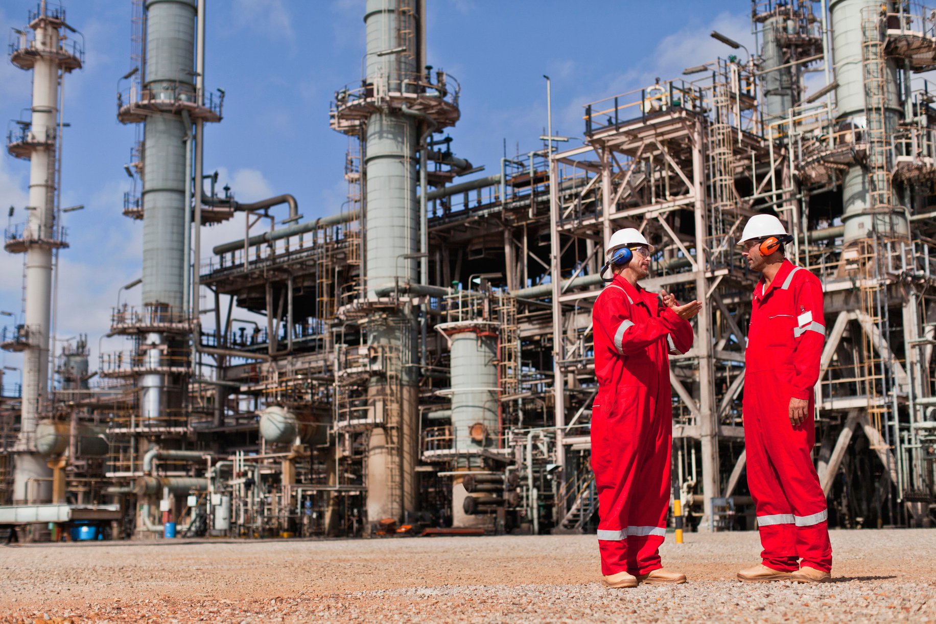 Workers talking at oil refinery